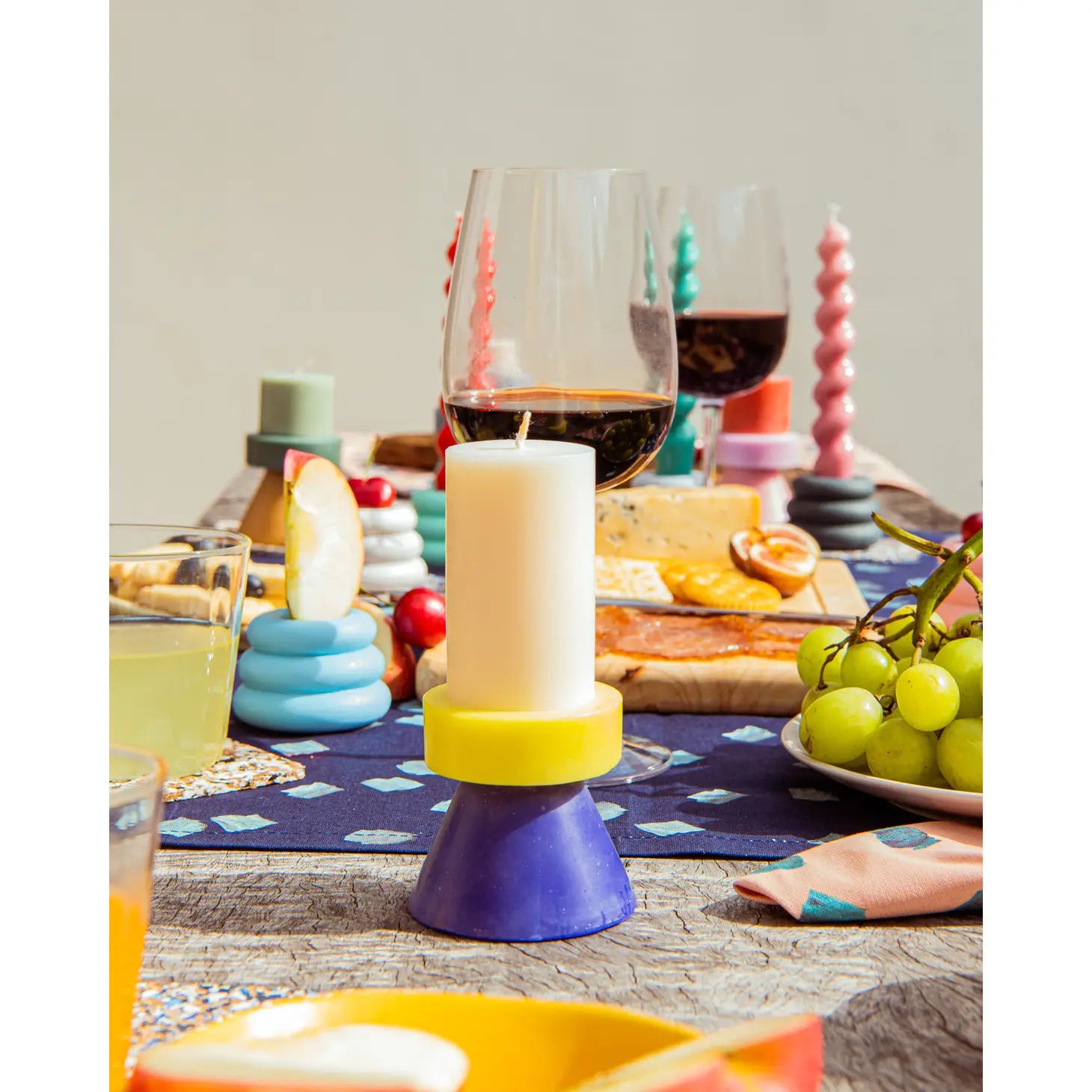 Yod + Co. Tall Stack Candle -  White / Yellow / Blue. On table